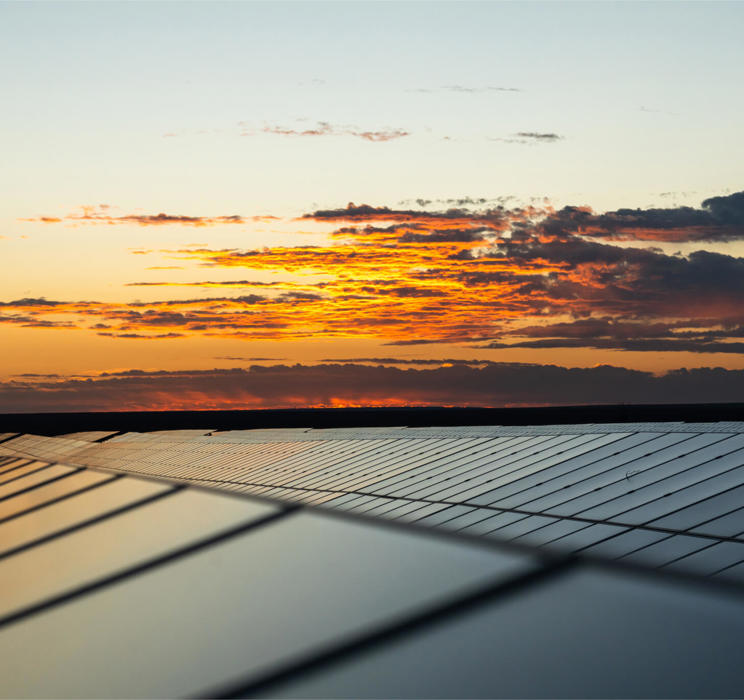 Solar panels reflecting a colourful sunset
